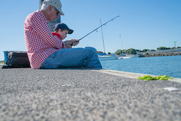Grandfather and grandson fishing
